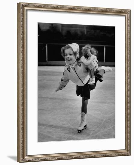 Child Skater Helen Ann Rousselle Holding Doll While Skating across the Ice-null-Framed Photographic Print