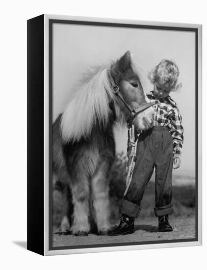 Child Standing Beside a Miniature Horse, Showing Size Comparison-Ed Clark-Framed Premier Image Canvas