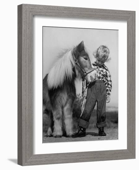 Child Standing Beside a Miniature Horse, Showing Size Comparison-Ed Clark-Framed Photographic Print