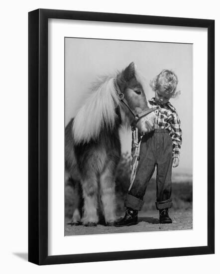 Child Standing Beside a Miniature Horse, Showing Size Comparison-Ed Clark-Framed Photographic Print