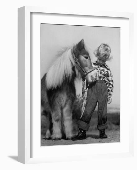 Child Standing Beside a Miniature Horse, Showing Size Comparison-Ed Clark-Framed Photographic Print