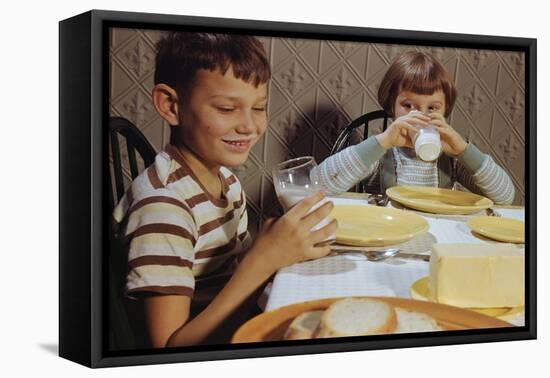 Children Drinking Milk at Dinner Table-William P. Gottlieb-Framed Premier Image Canvas