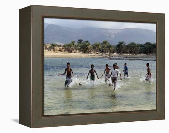 Children Enjoy a Boat Race in a Lagoon at Qalansiah, an Important Fishing Village in the Northwest-Nigel Pavitt-Framed Premier Image Canvas