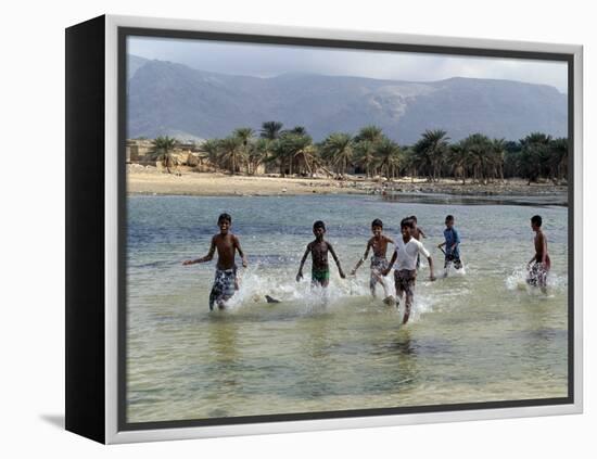 Children Enjoy a Boat Race in a Lagoon at Qalansiah, an Important Fishing Village in the Northwest-Nigel Pavitt-Framed Premier Image Canvas
