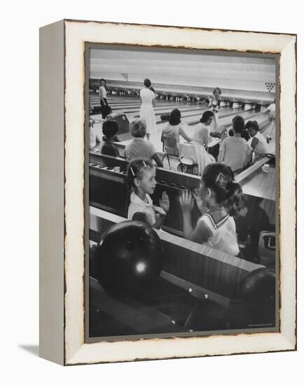 Children Entertaining Themselves While Their Mothers Compete in Bowling League-Stan Wayman-Framed Premier Image Canvas