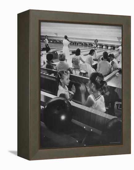 Children Entertaining Themselves While Their Mothers Compete in Bowling League-Stan Wayman-Framed Premier Image Canvas