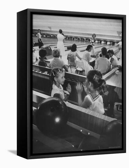 Children Entertaining Themselves While Their Mothers Compete in Bowling League-Stan Wayman-Framed Premier Image Canvas