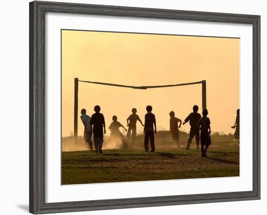 Children from the Toba Qom Ethnic Group Play Soccer During Indegenous Indian Day Celebration-null-Framed Photographic Print