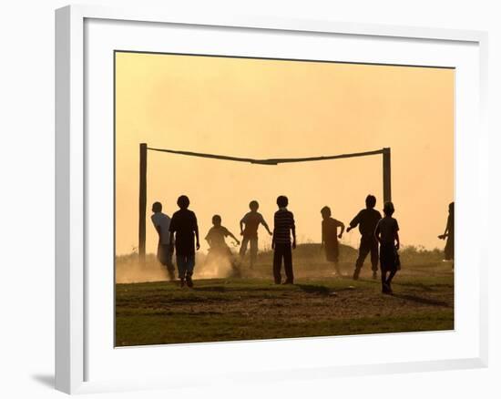 Children from the Toba Qom Ethnic Group Play Soccer During Indegenous Indian Day Celebration-null-Framed Photographic Print