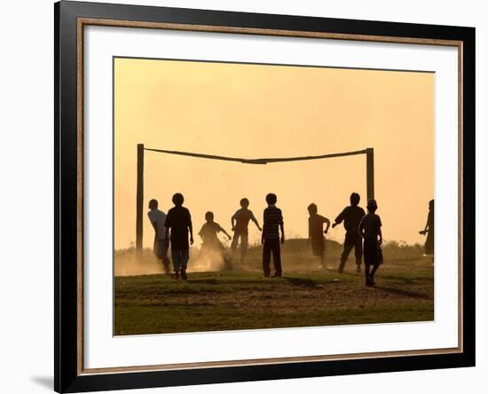 Children from the Toba Qom Ethnic Group Play Soccer During Indegenous Indian Day Celebration-null-Framed Photographic Print