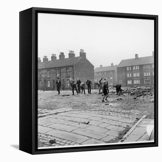 Children in a Deserted Liverpool Street Throw Bricks and Rubble-Henry Grant-Framed Premier Image Canvas