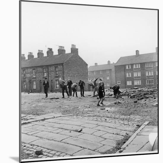 Children in a Deserted Liverpool Street Throw Bricks and Rubble-Henry Grant-Mounted Photographic Print