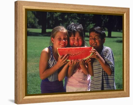 Children in Park Eating Watermelon-Mark Gibson-Framed Premier Image Canvas