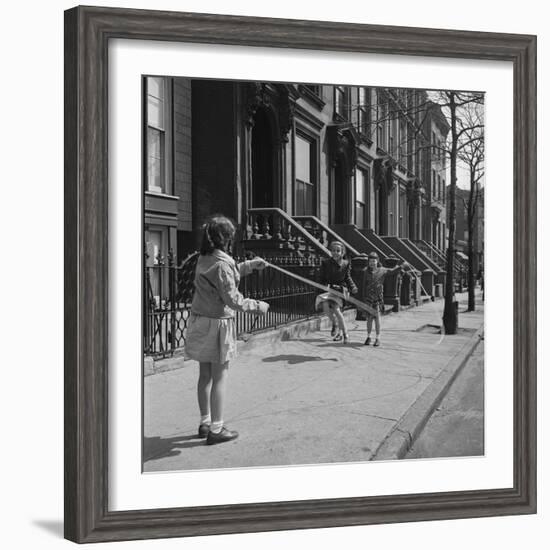 Children Jump Roping on Sidewalk Next to Brooklyn Brownstones, NY, 1949-Ralph Morse-Framed Photographic Print