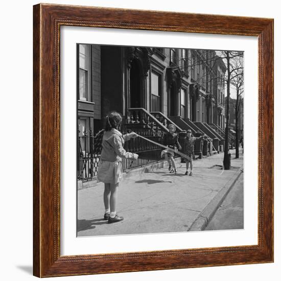 Children Jump Roping on Sidewalk Next to Brooklyn Brownstones, NY, 1949-Ralph Morse-Framed Photographic Print