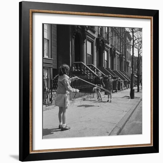 Children Jump Roping on Sidewalk Next to Brooklyn Brownstones, NY, 1949-Ralph Morse-Framed Photographic Print