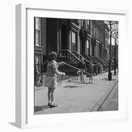 Children Jump Roping on Sidewalk Next to Brooklyn Brownstones, NY, 1949-Ralph Morse-Framed Photographic Print