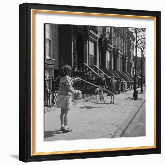 Children Jump Roping on Sidewalk Next to Brooklyn Brownstones, NY, 1949-Ralph Morse-Framed Photographic Print