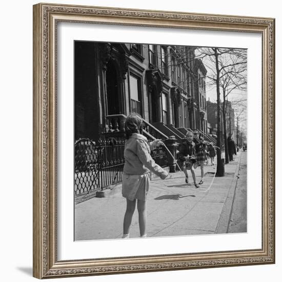 Children Jump Roping on Sidewalk Next to Brooklyn Brownstones, NY, 1949-Ralph Morse-Framed Photographic Print