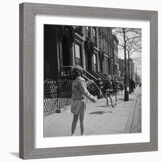 Children Jump Roping on Sidewalk Next to Brooklyn Brownstones, NY, 1949-Ralph Morse-Framed Photographic Print