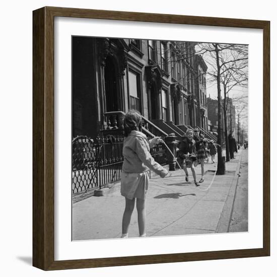 Children Jump Roping on Sidewalk Next to Brooklyn Brownstones, NY, 1949-Ralph Morse-Framed Photographic Print