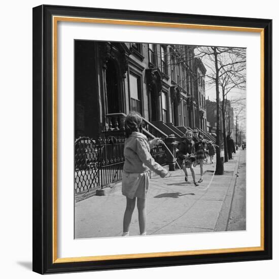 Children Jump Roping on Sidewalk Next to Brooklyn Brownstones, NY, 1949-Ralph Morse-Framed Photographic Print