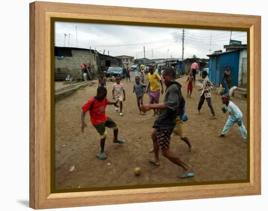 Children Play Soccer in an Impoverished Street in Lagos, Nigeria-null-Framed Premier Image Canvas