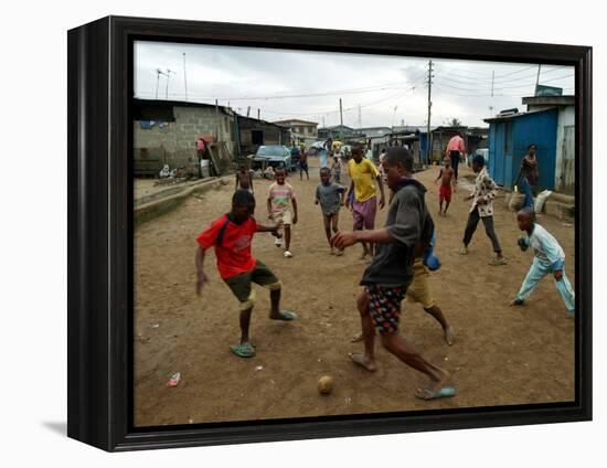 Children Play Soccer in an Impoverished Street in Lagos, Nigeria-null-Framed Premier Image Canvas