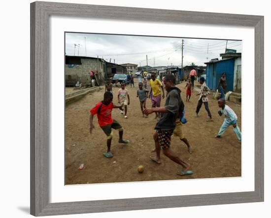 Children Play Soccer in an Impoverished Street in Lagos, Nigeria-null-Framed Photographic Print