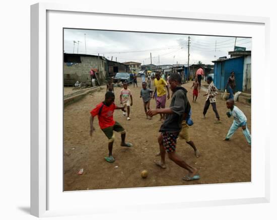 Children Play Soccer in an Impoverished Street in Lagos, Nigeria-null-Framed Photographic Print