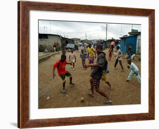 Children Play Soccer in an Impoverished Street in Lagos, Nigeria-null-Framed Photographic Print