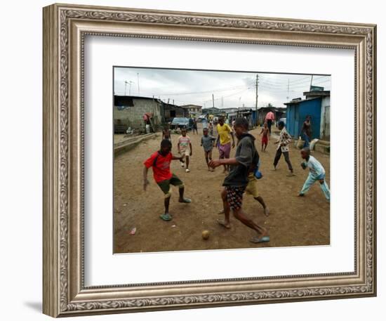 Children Play Soccer in an Impoverished Street in Lagos, Nigeria-null-Framed Photographic Print