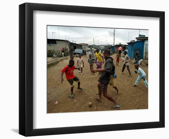 Children Play Soccer in an Impoverished Street in Lagos, Nigeria-null-Framed Photographic Print