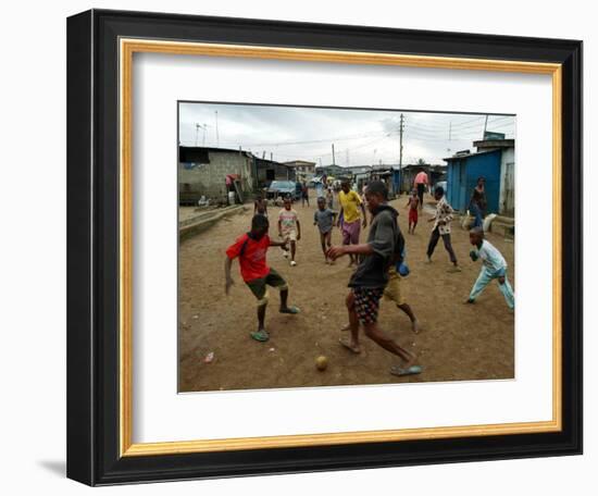 Children Play Soccer in an Impoverished Street in Lagos, Nigeria-null-Framed Photographic Print