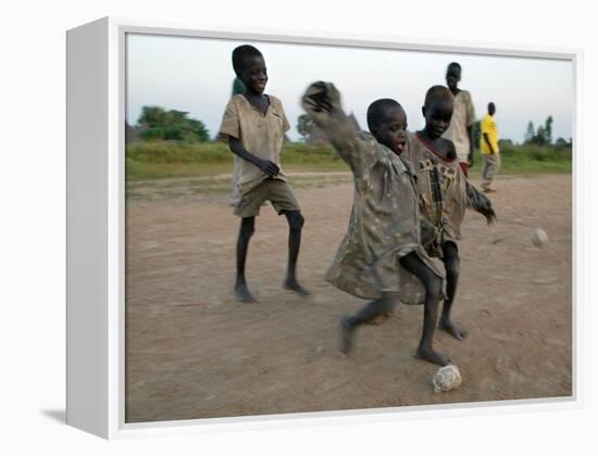 Children Play with Homemade Soccer Balls Made from Discarded Medical Gloves-null-Framed Premier Image Canvas