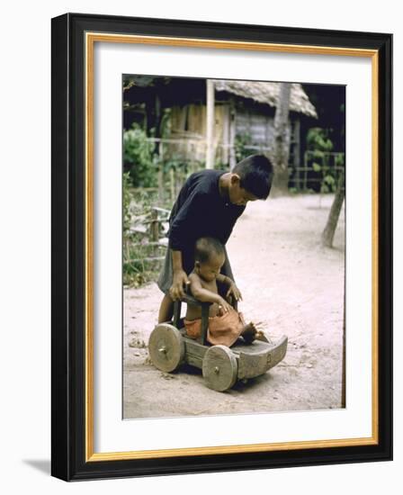 Children Playing on Wooden Wagon-John Dominis-Framed Photographic Print