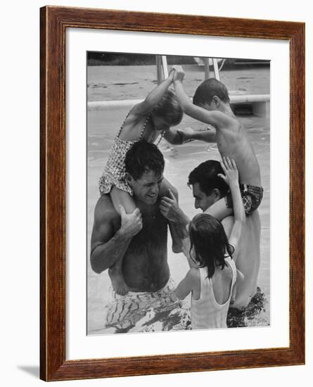 Children Playing with Their Fathers in the Swimming Pool-George Silk-Framed Premium Photographic Print