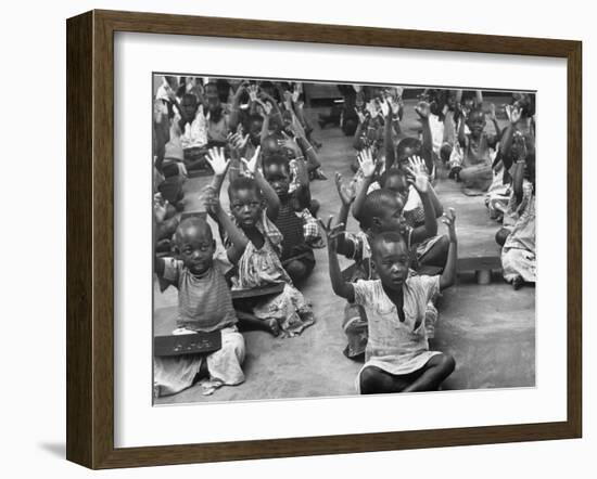 Children Raising their Hands in the Air During Kipuchi Kindergarten Classes-Dmitri Kessel-Framed Photographic Print