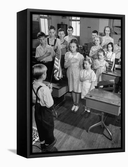 Children Reciting the Pledge of Allegiance as a Boy Holds the Us Flag in their Classroom-Bernard Hoffman-Framed Premier Image Canvas