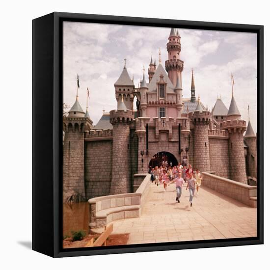 Children Running Through Gate of Sleeping Beauty's Castle at Walt Disney's Theme Park, Disneyland-Allan Grant-Framed Premier Image Canvas