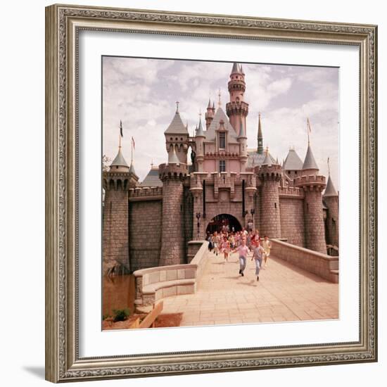 Children Running Through Gate of Sleeping Beauty's Castle at Walt Disney's Theme Park, Disneyland-Allan Grant-Framed Photographic Print