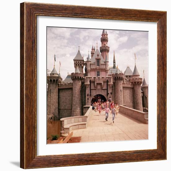 Children Running Through Gate of Sleeping Beauty's Castle at Walt Disney's Theme Park, Disneyland-Allan Grant-Framed Photographic Print