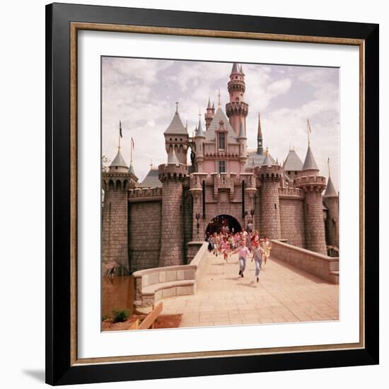 Children Running Through Gate of Sleeping Beauty's Castle at Walt Disney's Theme Park, Disneyland-Allan Grant-Framed Photographic Print