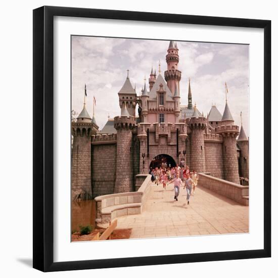 Children Running Through Gate of Sleeping Beauty's Castle at Walt Disney's Theme Park, Disneyland-Allan Grant-Framed Photographic Print