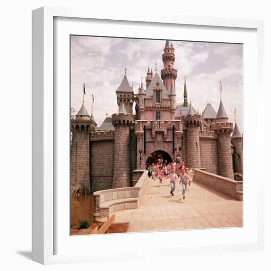 Children Running Through Gate of Sleeping Beauty's Castle at Walt Disney's Theme Park, Disneyland-Allan Grant-Framed Photographic Print