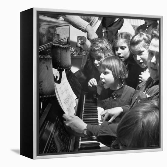 Children Singing Around the Piano at Orphanage-Tony Linck-Framed Premier Image Canvas