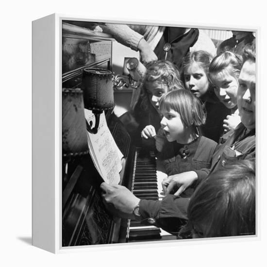 Children Singing Around the Piano at Orphanage-Tony Linck-Framed Premier Image Canvas