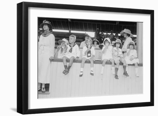 Children Sit on Wall in Front of Stands at the Ballpark and Eat Ice Cream Cones.-null-Framed Art Print