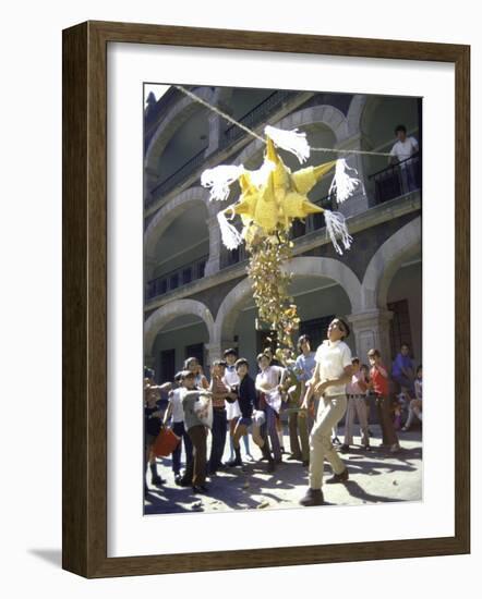 Children Taking Turns Breaking Pinata During Christmas Festival-John Dominis-Framed Photographic Print