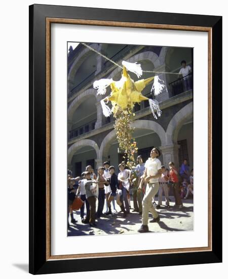 Children Taking Turns Breaking Pinata During Christmas Festival-John Dominis-Framed Photographic Print